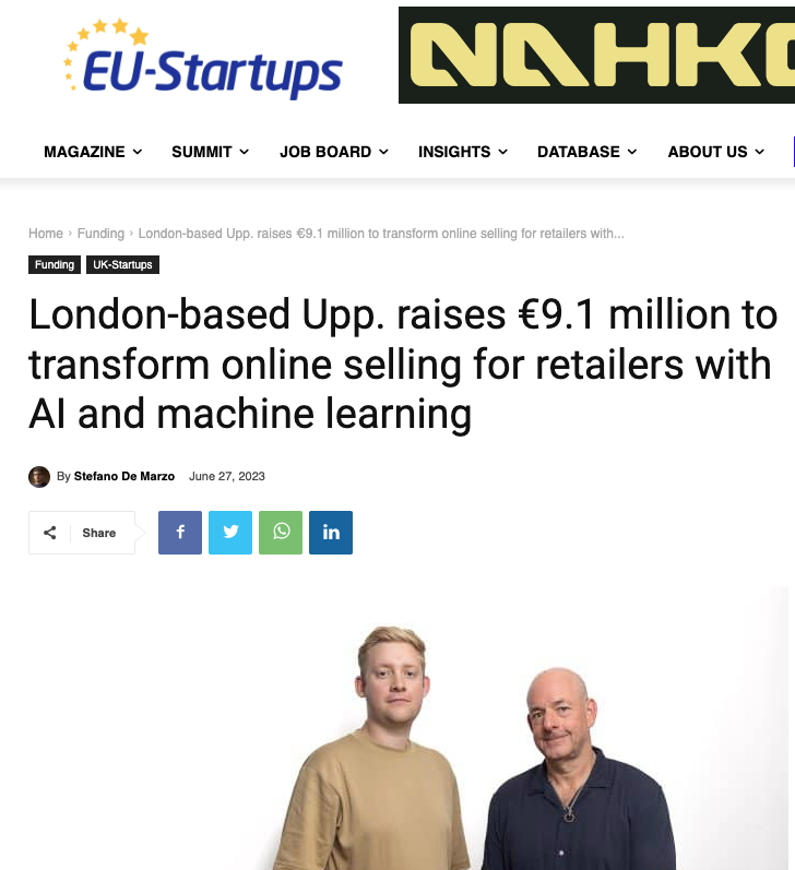 two men standing next to each other in front of a newspaper.